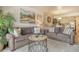 Cozy living room features neutral toned couches and bright coastal artwork at 5963 Midnight Pass Rd # 355, Sarasota, FL 34242