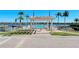 Waterfront pool with pergola, landscaping, and community area overlooking the water at 5963 Midnight Pass Rd # 355, Sarasota, FL 34242