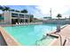 Resort style swimming pool on a clear day at 5963 Midnight Pass Rd # 355, Sarasota, FL 34242