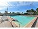 Serene swimming pool with invitingly clear water, surrounded by lounge chairs and tropical palms at 5963 Midnight Pass Rd # 355, Sarasota, FL 34242