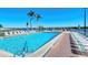 Community pool with lounge chairs and tables, offering waterfront views at 5963 Midnight Pass Rd # 355, Sarasota, FL 34242