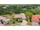 Stunning aerial view of a home with a tile roof, a well-manicured lawn, and a nearby lake at 6222 Stillwater Ct, Bradenton, FL 34201