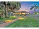 Expansive backyard with a long path, lush lawn, and screened-in pool area, perfect for outdoor enjoyment and entertaining at 6222 Stillwater Ct, Bradenton, FL 34201