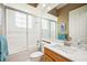 Bathroom featuring a tub and shower combo with a glass enclosure and a vanity at 6222 Stillwater Ct, Bradenton, FL 34201