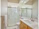 Bathroom with tiled shower, glass enclosure, marble vanity, and updated fixtures at 6222 Stillwater Ct, Bradenton, FL 34201