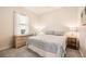 Cozy bedroom with a patterned bedspread, a dresser, and a window with sheer curtains at 6222 Stillwater Ct, Bradenton, FL 34201