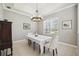 Elegant dining room with a chandelier, tiled flooring, and large window for ample natural light at 6222 Stillwater Ct, Bradenton, FL 34201