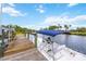 Waterfront dock, complete with boat, offers direct access to scenic waterways, providing an idyllic setting for relaxation and adventure at 6222 Stillwater Ct, Bradenton, FL 34201