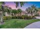 Charming single-story home with lush landscaping and mature palm trees at 6222 Stillwater Ct, Bradenton, FL 34201