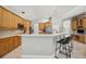 Spacious kitchen with wood cabinets, a breakfast bar, and modern appliances, perfect for cooking and entertaining at 6222 Stillwater Ct, Bradenton, FL 34201
