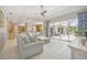 Open-concept living room with tile flooring, comfortable seating, and sliding glass doors to the outdoor patio at 6222 Stillwater Ct, Bradenton, FL 34201