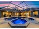 Stunning screened-in pool area with a bubbling spa and ample space for outdoor entertaining under the sunset sky at 6222 Stillwater Ct, Bradenton, FL 34201