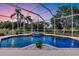 Captivating screened-in pool and spa offers a serene escape with pristine waters and lush garden surroundings at 6222 Stillwater Ct, Bradenton, FL 34201