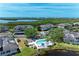 A wide aerial view showcases the condo buildings adjacent to a pool and the tranquil waterfront scenery at 628 Estuary Dr, Bradenton, FL 34209