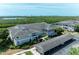 Gorgeous aerial shot of the condo building, waterfront views, and dedicated parking at 628 Estuary Dr, Bradenton, FL 34209