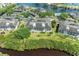 An aerial view showing the condo buildings and surrounding landscaping by a serene pond at 628 Estuary Dr, Bradenton, FL 34209