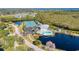 Aerial view of complex with tennis courts, pool, clubhouse, and natural surroundings at 628 Estuary Dr, Bradenton, FL 34209