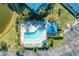 Aerial view of community pool and spa featuring lounge chairs, umbrellas, and landscaped surroundings at 628 Estuary Dr, Bradenton, FL 34209