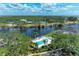 A stunning aerial view of a community pool, waterway, and lush green surroundings creating an oasis at 628 Estuary Dr, Bradenton, FL 34209