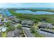 Aerial view of condos with waterfront and lake views and assigned carport parking at 628 Estuary Dr, Bradenton, FL 34209