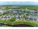 Beautiful aerial view of waterfront condos with lush landscaping, community pool, and water views at 628 Estuary Dr, Bradenton, FL 34209