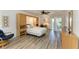Bright bedroom with tile floors, ceiling fan, and a balcony at 628 Estuary Dr, Bradenton, FL 34209