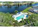 Aerial view highlighting a sparkling community pool, complemented by lush greenery and waterfront scenery at 628 Estuary Dr, Bradenton, FL 34209