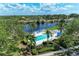 Overhead shot of the beautiful pool area with palm trees and patio, perfect for relaxation and leisure at 628 Estuary Dr, Bradenton, FL 34209