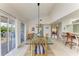 Bright dining room with glass table, wicker chairs, and sliding glass doors to the outside at 628 Estuary Dr, Bradenton, FL 34209