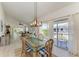 Bright dining area with large windows, access to balcony, and views of living area at 628 Estuary Dr, Bradenton, FL 34209