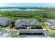 Exterior view showcasing a well-maintained condo building with ample parking and lush green landscaping at 628 Estuary Dr, Bradenton, FL 34209
