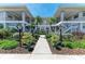 Well-maintained condo building with symmetrical design, lush landscaping and convenient walkways at 628 Estuary Dr, Bradenton, FL 34209