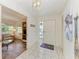 Bright condo foyer with tile flooring, nautical decor, and a view of the living area at 628 Estuary Dr, Bradenton, FL 34209