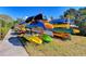 Kayak storage area showcasing a variety of colorful kayaks and canoes neatly organized on wooden racks at 628 Estuary Dr, Bradenton, FL 34209
