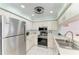 Modern kitchen with stainless steel appliances and white cabinets at 628 Estuary Dr, Bradenton, FL 34209