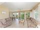 Inviting sunroom features large windows with views, comfortable seating, and neutral colors at 628 Estuary Dr, Bradenton, FL 34209