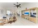 Bright living room features tile floors, ceiling fan, and an open layout leading to the dining area at 628 Estuary Dr, Bradenton, FL 34209