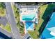 Aerial view showcasing a pool and jacuzzi with lounge chairs surrounded by landscaping at 628 Estuary Dr, Bradenton, FL 34209