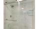 Shower features a glass door, a rain shower head, and tile walls at 628 Estuary Dr, Bradenton, FL 34209