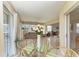 Sunroom with glass table and chairs and views of the outdoors at 628 Estuary Dr, Bradenton, FL 34209
