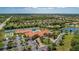 Beautiful aerial view of community center, tennis courts, parking lot, and surrounding landscaping and community homes at 6324 41St E Ct, Sarasota, FL 34243