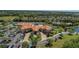 Aerial view of the community clubhouse with tennis courts, pool, manicured landscaping and ample parking at 6324 41St E Ct, Sarasota, FL 34243