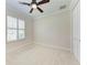 This bedroom features plush carpeting, shuttered windows, and a ceiling fan at 6324 41St E Ct, Sarasota, FL 34243