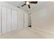Neutral bedroom with carpet, fan, and closet at 6324 41St E Ct, Sarasota, FL 34243