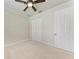 Clean, neutral bedroom with fan and closet at 6324 41St E Ct, Sarasota, FL 34243