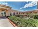 The exterior of the community clubhouse and lush landscaping featuring manicured bushes and mulched flowerbeds at 6324 41St E Ct, Sarasota, FL 34243
