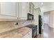 Bright kitchen features granite counters, stainless appliances, and tiled backsplash at 6324 41St E Ct, Sarasota, FL 34243