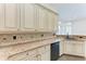 Kitchen featuring granite countertops and white cabinets at 6324 41St E Ct, Sarasota, FL 34243