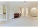 Bright living room with carpet floors, a neutral color palette, and arched doorways at 6324 41St E Ct, Sarasota, FL 34243