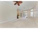 Open living room with neutral color palette, carpet floors and arched doorways at 6324 41St E Ct, Sarasota, FL 34243